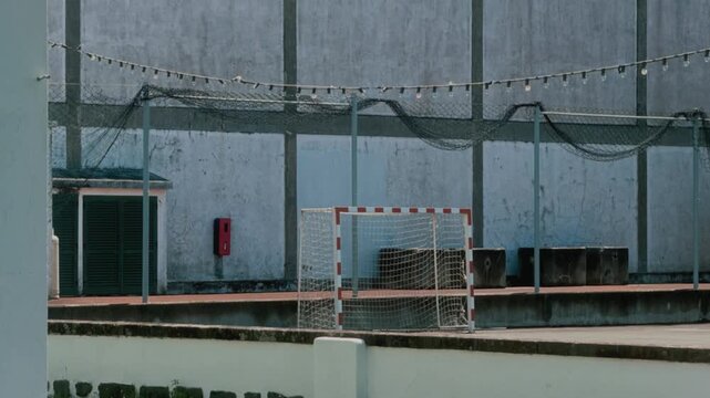 Empty street soccer goal with net on an outdoor futsal court under blue sky with clouds, S&atilde;o Miguel, Azores, Portugal