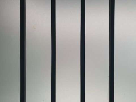 Minimalist White Wall with Vertical Black Iron Lines