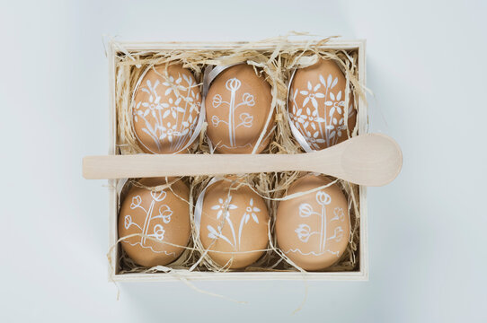 Painted easter eggs in box with straw