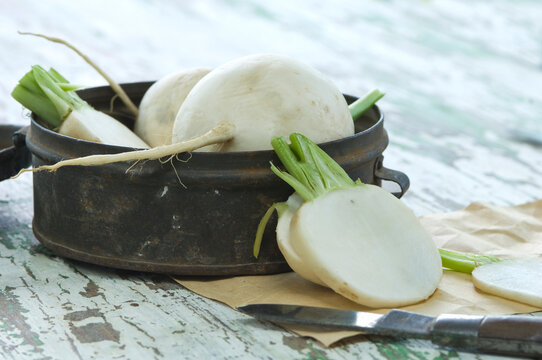 Sliced and whole radish and an old tin can