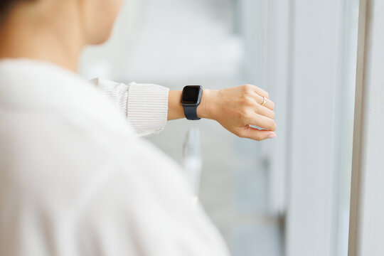 Businesswoman checks her smartwatch for time management at the office