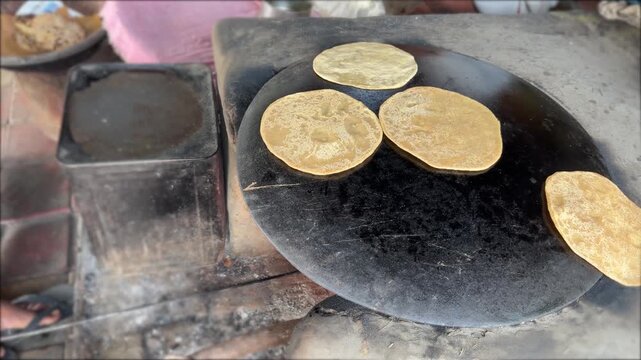 Inverted griddle ya ulte tawe ki roti making baking bread chapati on the mud stove or clay stove traditional food 4k footage