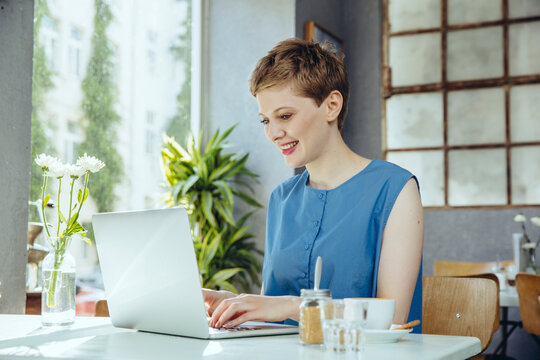 Woman working in cafe with her laptop