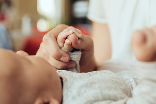 Close-up of mother holding newborn baby?s hand