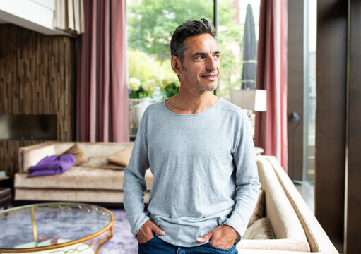 Mature man enjoys leisure time in the modern living room