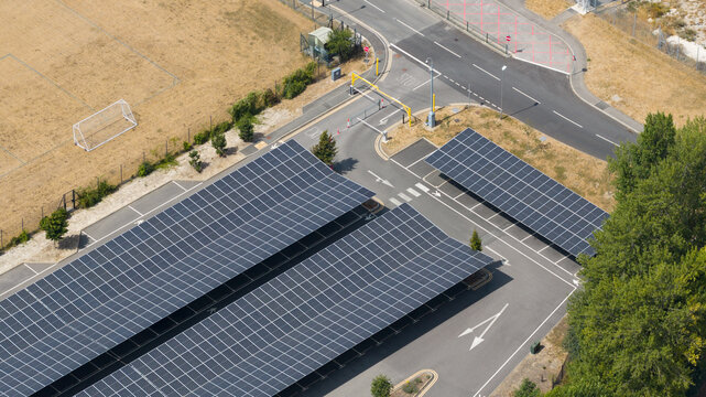 Aerial view shows an empty solar panel carport in a parking lot