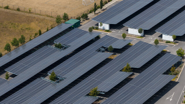 Aerial view of a large parking lot with solar panel carports