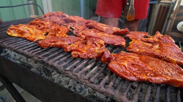 Pork Steak in Red Marinade Cooks on Charcoal Grill Slowly Today