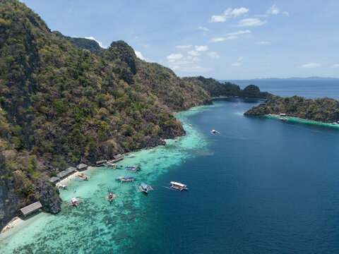 An aerial view shows boats in the turquoise sea of Coron Palawan