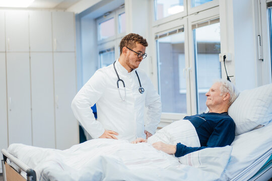 Doctor consulting patient in hospital room during medical visit