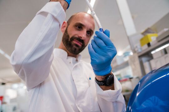 Male scientist examines liquid sample in a hightech laboratory
