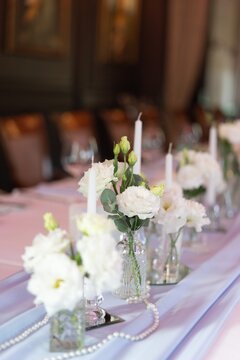 Wedding table decor freesia flowers, candles, tablecloth