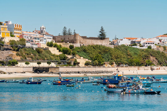 Fishing boats float in the port of the historic coastal town Sines