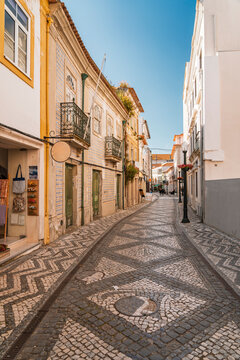 Empty cobblestone alley features traditional architecture in Aveiro