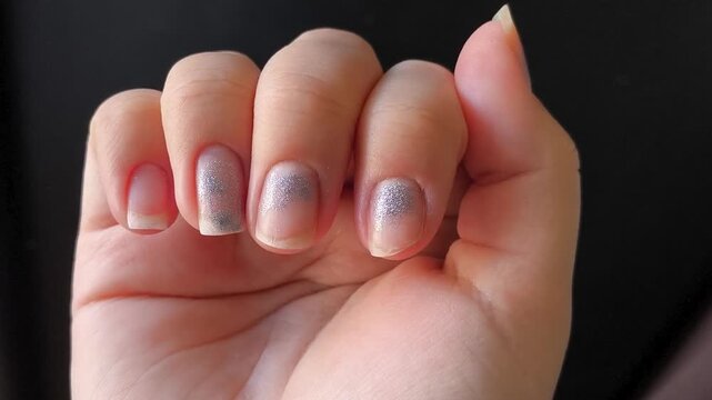 a hand with chipped and broken nails, representing neglected manicure, nail damage and poor grooming.