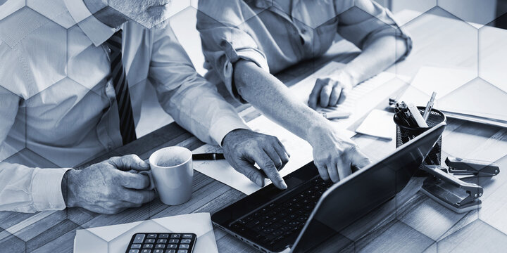 Two mature business people working together, geometric pattern