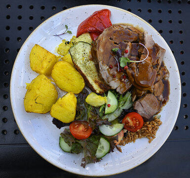 Lamb with side dishes from Latvia on a plate