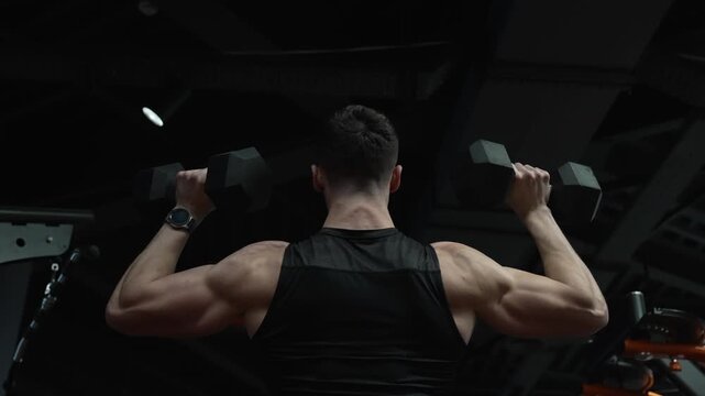 Gym workout. Sport athlete man with dumbbell. Arm shred. Biceps muscle. Strong triceps. Man exercising with dumbbell. Man athlete lifting dumbbell. Strong man do sport exercise