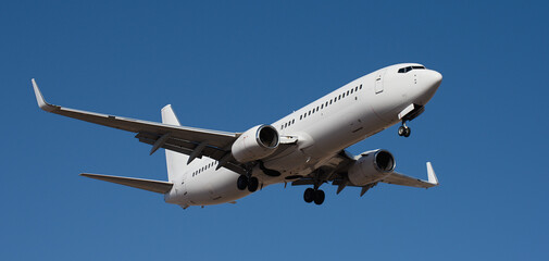 Fototapeta premium The plane lands, passenger airliner. The plane lands. Airplane, passengers flying in the blue sky, preparing to land at the airport