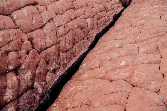 Red rock formation with crack desert terrain