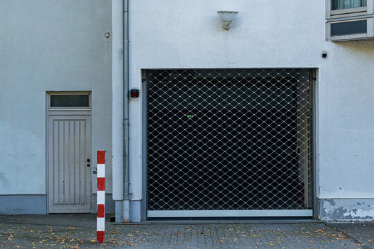Garage door and side entrance on a quiet street in a city