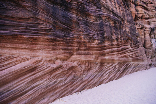 Sand and stratified rock walls slot canyon Utah