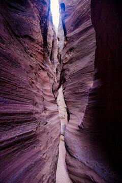 Narrow slot canyon with layered rock walls