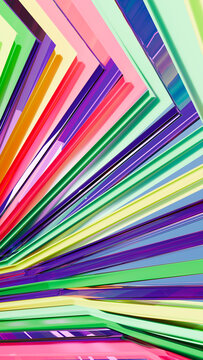 Colorful plastic drinking straws arranged in a vibrant pattern