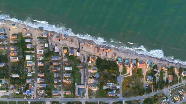 Top-down aerial view of coastal erosion affecting oceanfront houses in Buxton on Hatteras Island in the Outer Banks of North Carolina, United States