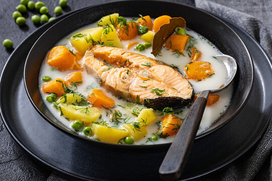 Creamy salmon soup with carrots, rutabaga, potato