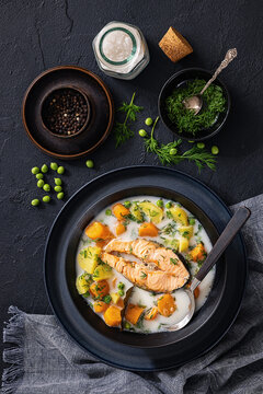 fish soup featuring a large chunk of salmon