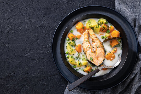 Creamy salmon soup with carrots, rutabaga, potato