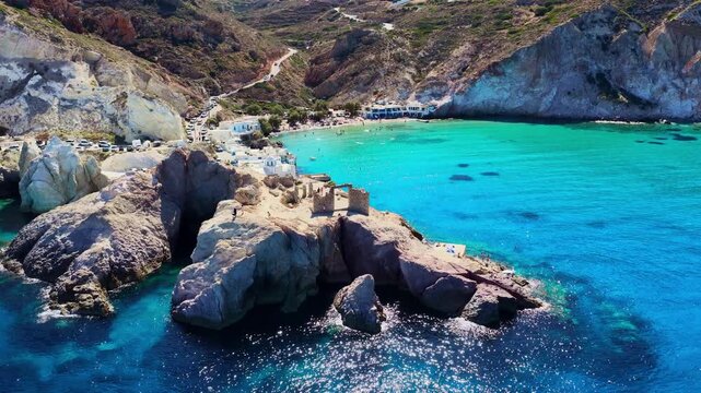 drone shot of Firopotamos beach and traditional Greek fishing village in Milos, Greece, crystal clear water of the Aegean Sea on a Greek island in the Mediterranean, summer vacation on Milos, aerial 