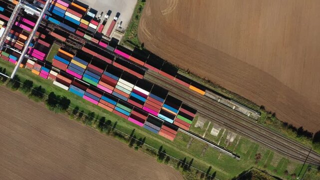 Aerial view of containers at railway. Big container terminal on a railroad with open storage area.