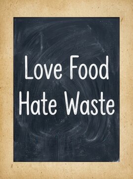 Love Food Hate Waste Message Written on a Chalkboard for Environmental Awareness and Sustainability Concept