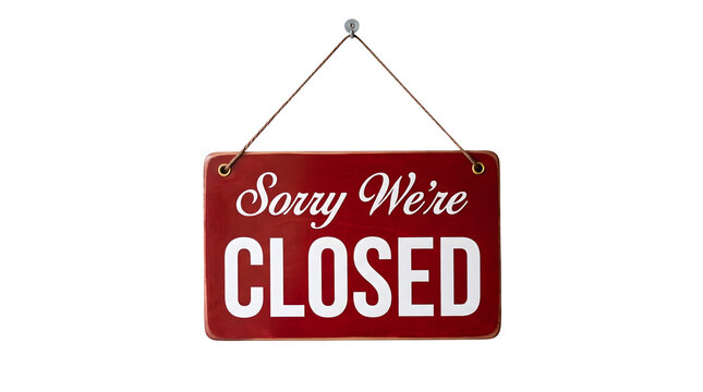 Red Sorry We are Closed sign hanging on a string against a plain black background indicating business closure