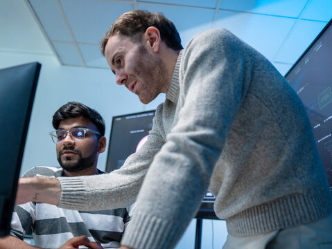 Software engineering use computer working development office are assisting algorithm systems or verifying code. Programmer teamwork using artificial intelligence on laptop analysis or writing coding