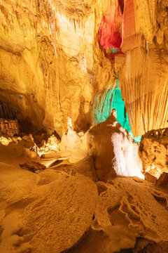 Colorful cave formations in a well-lit underground space