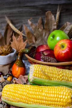 Autumn harvest still life with corn and fresh apples