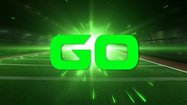 Tracking shot go logo bursting into bright green sparks and zooming forward over illuminated football field in stadium