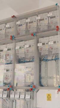 Vertical Screen: Details of electrical installations show numerous electricity meters. The arrangement of wires connects each meter to a central electrical panel for distribution.