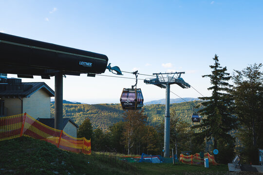 Szczyrk, Poland, September 27, 2026. TMR gondola by Leitner crosses an autumn mountain forest at Szczyrk Mountain Resort