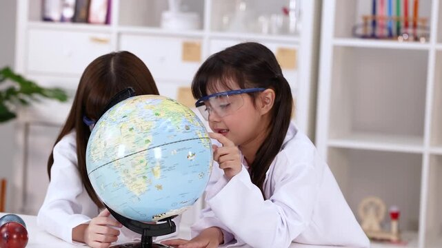 Young Girls in Lab Coats Studying World Globe in Science Class