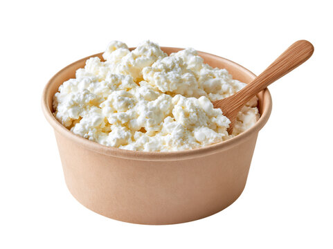 White curd cheese in brown bowl with wooden spoon.