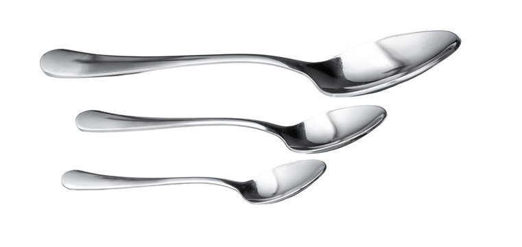 Different sizes of silver spoons arranged in a row on a plain background