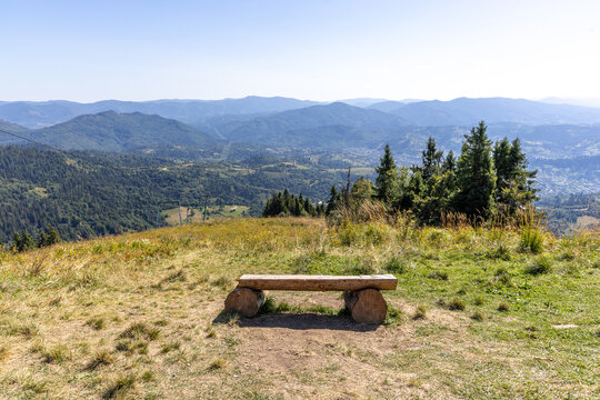 Wooden bench in the summer mountains