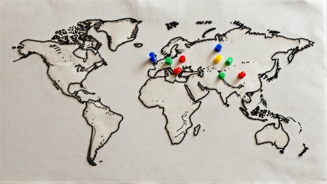 Colorful pins mark locations on a stitched world map, hinting at global journeys.