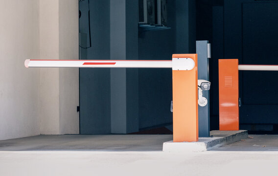 Automatic barrier gate system with a surveillance camera providing security and regulating vehicle access to a parking area