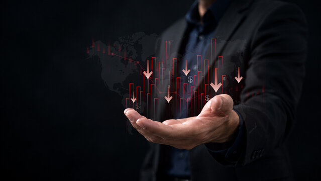 financial market downturn and global economic crisis. businessman holding falling red stock charts, symbolizing crisis, investment loss, inflation impact, and bearish trend across world economy