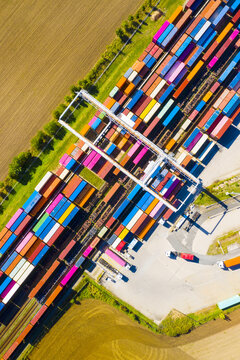  Aerial view of containers at railway. Big container terminal on a railroad with open storage area.